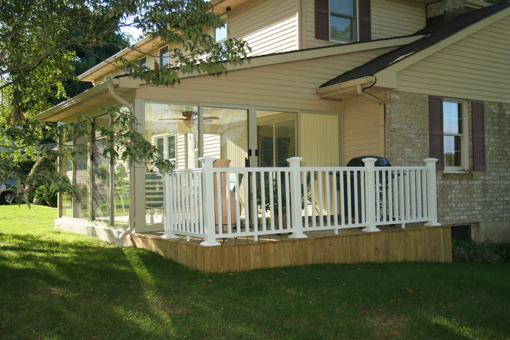 a house with a sunroom deck and a porch